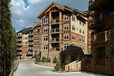 a large apartment building in the middle of a street at Luxurious 2 BR in River Run Village with Ski in ski out condo in Dillon