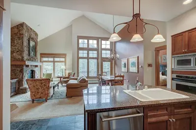a kitchen with a sink and a living room at Luxurious 2 BR in River Run Village with Ski in ski out condo in Dillon