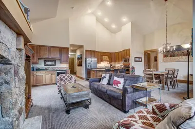 a living room with a couch and a table at Luxurious 3 BR in River Run Village Featuring Ski in, ski out condo in Dillon