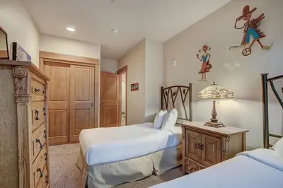 a bedroom with two beds and a dresser at Luxurious 3 BR in River Run Village Featuring Ski in, ski out condo in Dillon