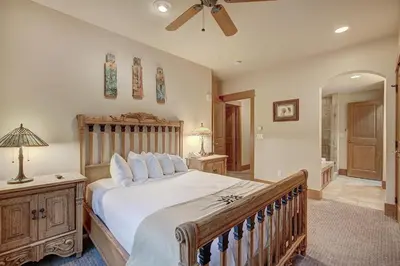 a bedroom with a large bed and a ceiling fan at Luxurious 3 BR in River Run Village Featuring Ski in, ski out condo in Dillon