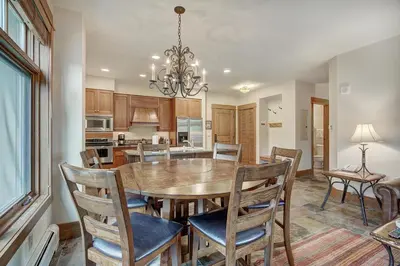 a kitchen and dining room with a table and chairs at Luxurious 2 BR in River Run Village Featuring Ski in ski-out condo in Dillon