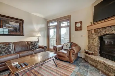 a living room with a couch and a fireplace at Luxurious 2 BR in River Run Village Featuring Ski in ski-out condo in Dillon