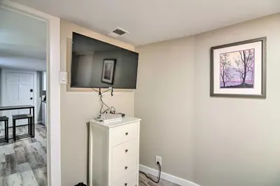 a room with a white dresser and a picture on the wall at Fresh Downtown Longmont Apartment - Walk to Main! in Longmont
