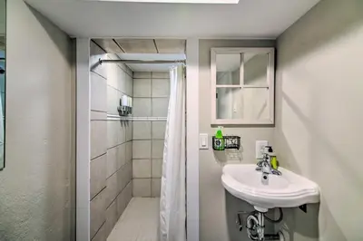 a bathroom with a sink and a shower at Fresh Downtown Longmont Apartment - Walk to Main! in Longmont