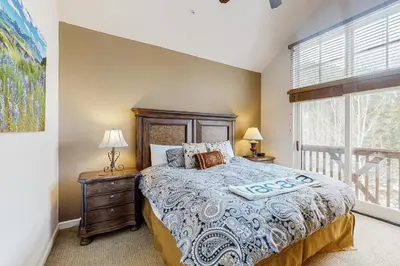 a bedroom with a bed and a window at Seasons 1840 in Keystone
