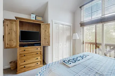 a bedroom with a bed and a tv on a dresser at Seasons 1840 in Keystone