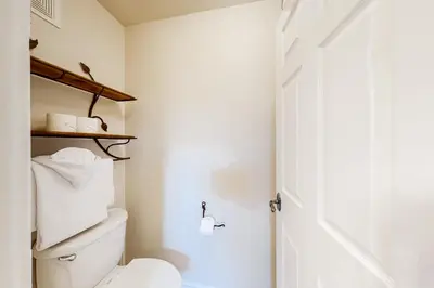 a bathroom with a white toilet and a white door at Seasons 1840 in Keystone