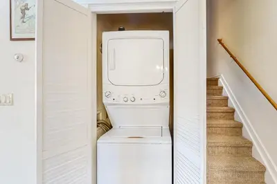 a washer and dryer in a hallway with a staircase at Seasons 1840 in Keystone