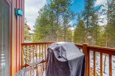 a balcony with a table and chairs on a deck at Seasons 1840 in Keystone