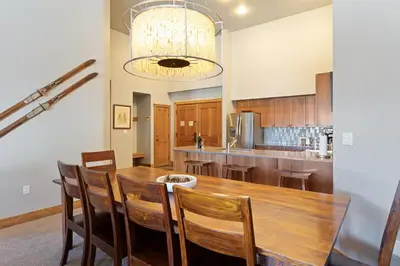 a kitchen with a wooden table and chairs at 2300 Red Hawk Lodge condo in Keystone