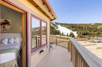 a balcony with a bed and a view of a ski slope at 2300 Red Hawk Lodge condo in Keystone
