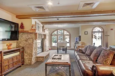 a living room with a couch and a fireplace at 2300 Red Hawk Lodge condo in Keystone