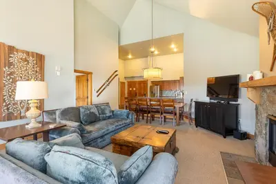 a living room with a couch and a table at 2300 Red Hawk Lodge condo in Keystone