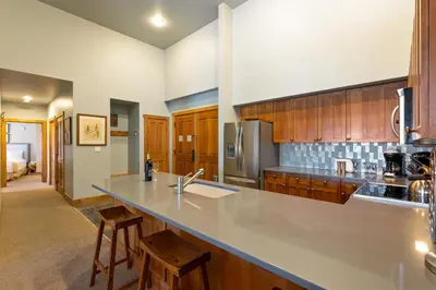 a large kitchen with a counter top and wooden cabinets at 2300 Red Hawk Lodge condo in Keystone