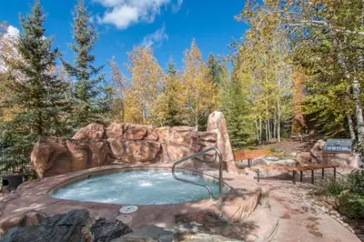 a jacuzzi tub in the middle of a forest at Beautiful 3 Bedroom Mountain Condo In River Run Village With Hot Tub Access And Walking Distance To The Gondola in Keystone