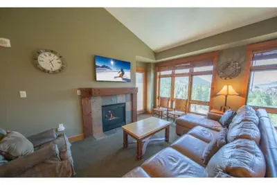 a living room with a couch and a fireplace at Beautiful 3 Bedroom Mountain Condo In River Run Village With Hot Tub Access And Walking Distance To The Gondola in Keystone