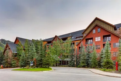 a large red building with trees in front of it at Beautiful 3 Bedroom Mountain Condo In River Run Village With Hot Tub Access And Walking Distance To The Gondola in Keystone