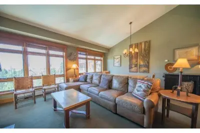 a living room with a couch and a table at Beautiful 3 Bedroom Mountain Condo In River Run Village With Hot Tub Access And Walking Distance To The Gondola in Keystone