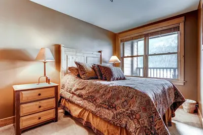 a bedroom with a bed and a window at Beautiful 1 Bedroom Mountain Condo In River Run Village With Hot Tub Access And Walking Distance To The Gondola in Keystone