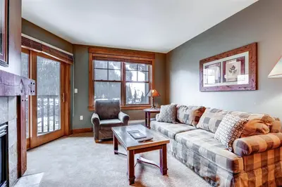 a living room with a couch and a table at Beautiful 1 Bedroom Mountain Condo In River Run Village With Hot Tub Access And Walking Distance To The Gondola in Keystone