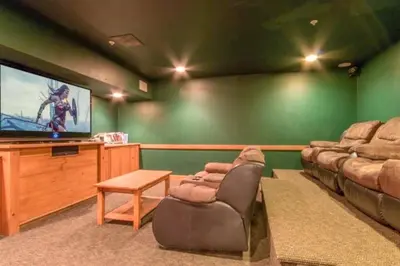 a living room with a flat screen tv and chairs at Beautiful 1 Bedroom Mountain Condo In River Run Village With Hot Tub Access And Walking Distance To The Gondola in Keystone