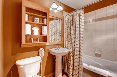 a bathroom with a toilet and a sink and a tub at Beautiful 1 Bedroom Mountain Condo In River Run Village With Hot Tub Access And Walking Distance To The Gondola in Keystone