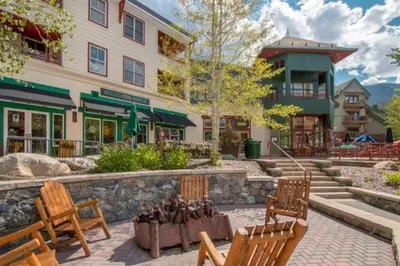 a group of benches in front of a building at Beautiful 1 Bedroom Mountain Condo In River Run Village With Hot Tub Access And Walking Distance To The Gondola in Keystone