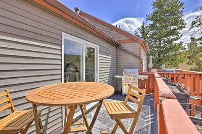 a patio with a wooden table and two chairs at Frisco Mountain Hub Walk to Main Street in Frisco