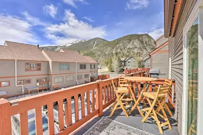 a balcony with a wooden table and chairs on it at Frisco Mountain Hub Walk to Main Street in Frisco