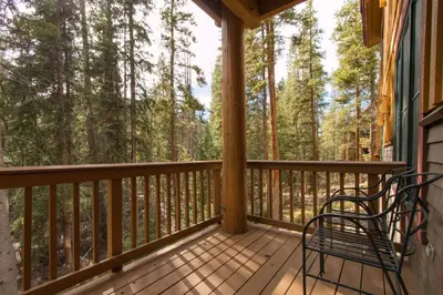 a screened in porch with two chairs on it at Charming Condo Nestled In The East Keystone Resort Neighborhood, Shuttle To Ski Slopes, Outdoor Pool And Hot Tub in Dillon