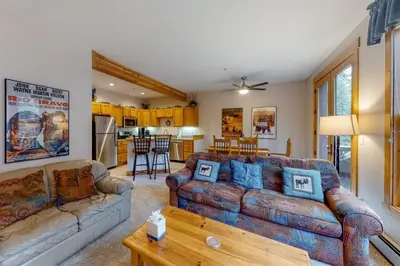 a living room with a couch and a table at Charming Condo Nestled In The East Keystone Resort Neighborhood, Shuttle To Ski Slopes, Outdoor Pool And Hot Tub in Dillon