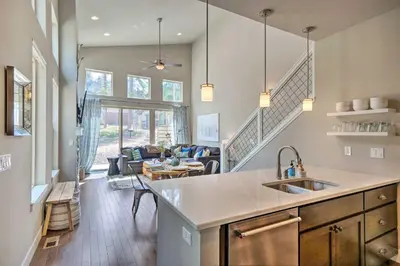 a kitchen with a sink and a living room at Rendezvous Buckhorn Cabin By Hiking Trails in Winter Park