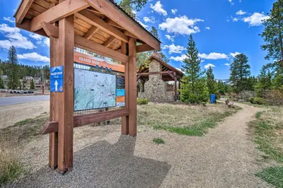 a wooden sign in the middle of a road at Rendezvous Buckhorn Cabin By Hiking Trails in Winter Park