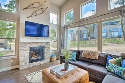 a living room with a couch and a fireplace at Rendezvous Buckhorn Cabin By Hiking Trails in Winter Park