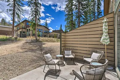 a patio with chairs and a table in front of a house at Rendezvous Buckhorn Cabin By Hiking Trails in Winter Park