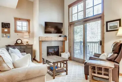 a living room with a couch and a fireplace at Lakeside Village 3 Bedroom Townhome At The Seasons In Keystone in Dillon