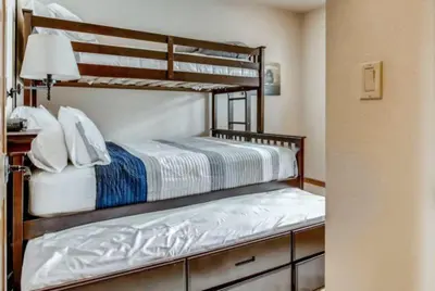 a bedroom with two bunk beds and a desk at Lakeside Village 3 Bedroom Townhome At The Seasons In Keystone in Dillon