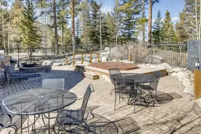 a patio with a table and chairs and a bench at Lakeside Village 3 Bedroom Townhome At The Seasons In Keystone in Dillon