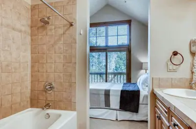 a bathroom with a sink and a bath tub next to a window at Lakeside Village 3 Bedroom Townhome At The Seasons In Keystone in Dillon