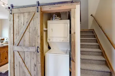 a washer and dryer in a room with a staircase at Lakeside Village 3 Bedroom Townhome At The Seasons In Keystone in Dillon