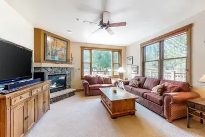 a living room with couches and a flat screen tv at Red Hawk Townhomes 2 Bedroom Rental In River Run Village in Dillon
