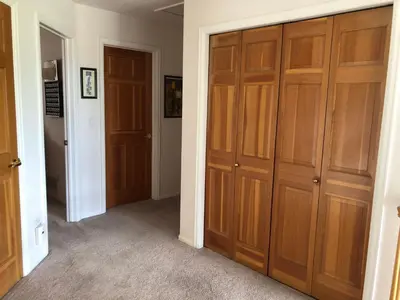 a hallway with two wooden cabinets and two doors at 1 or 2 bedrooms with bath at Indian Peaks golf course in Lafayette