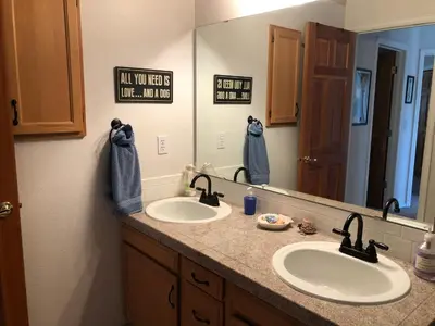 a bathroom with two sinks and a large mirror at 1 or 2 bedrooms with bath at Indian Peaks golf course in Lafayette