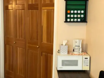 a microwave sitting on a counter next to a door at 1 or 2 bedrooms with bath at Indian Peaks golf course in Lafayette