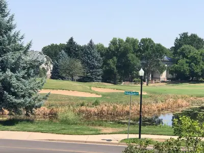 a golf course with a pond and a golf green at 1 or 2 bedrooms with bath at Indian Peaks golf course in Lafayette