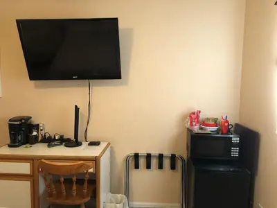 a room with a desk and a television on the wall at 1 or 2 bedrooms with bath at Indian Peaks golf course in Lafayette