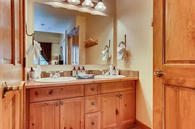 a bathroom with two sinks and a large mirror at Beautiful 2 Bedroom Mountain Condo In River Run Village With Hot Tub Access And Walking Distance To The Gondola in Keystone