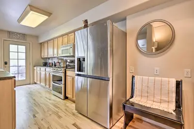 a kitchen with a stainless steel refrigerator and a mirror at Walk to Frisco Main St Townhome Steps to Trail! in Frisco