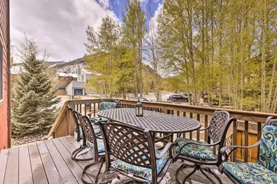 a patio with a table and chairs on a deck at Walk to Frisco Main St Townhome Steps to Trail! in Frisco